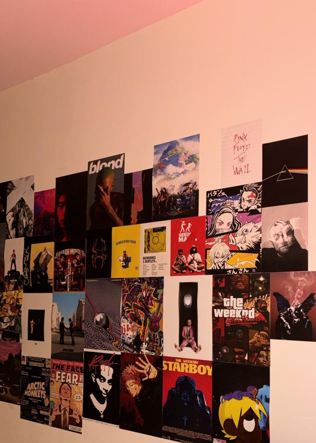 A bedroom wall covered in music, anime and film posters from The Print Lab